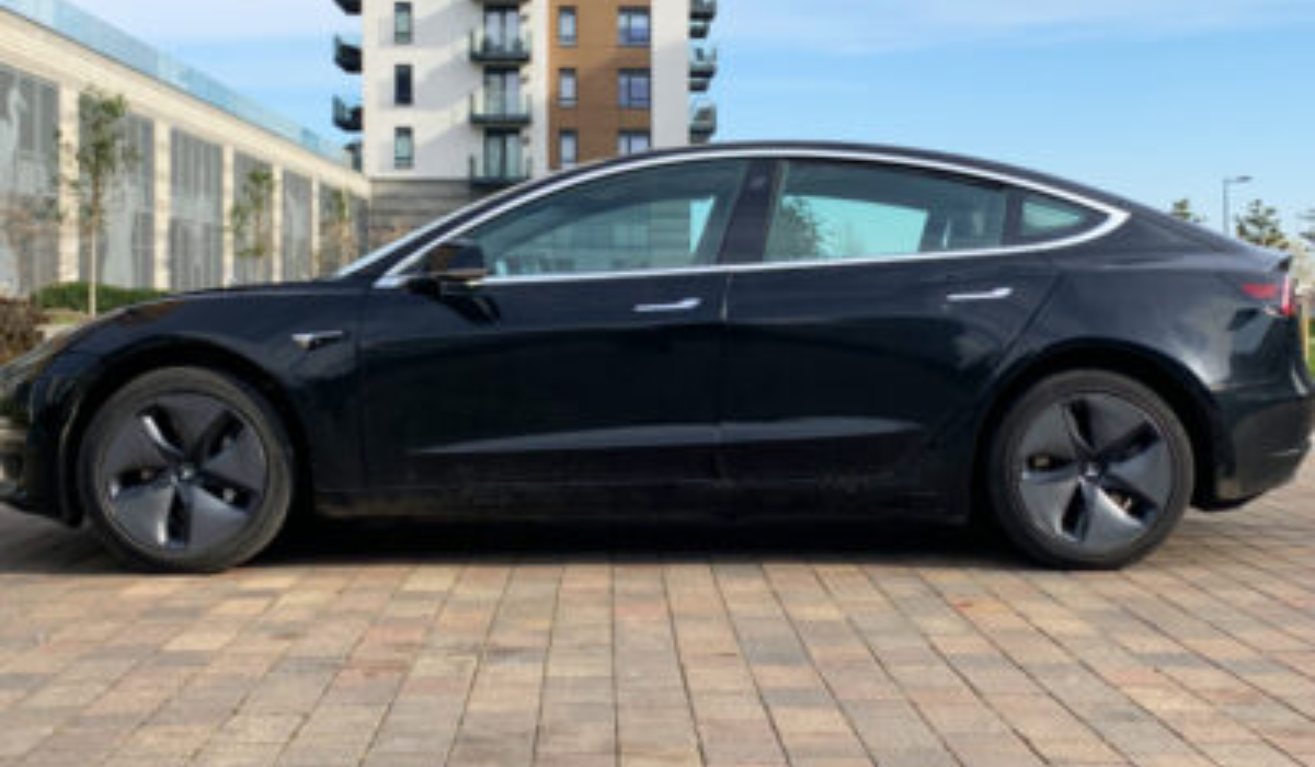 Black Tesla Model 3 facing left
