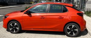 Orange Vauxhall Corsa-e facing left